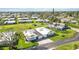 Aerial view of a single story home, showcasing the meticulously landscaped yard and the home's surroundings at 3220 Southfield Ln # 810, Sarasota, FL 34239