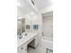 Bright bathroom with white vanity, framed mirror and combination tub shower at 3220 Southfield Ln # 810, Sarasota, FL 34239