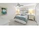 Cozy bedroom with a ceiling fan, a large window, and two bedside tables at 3220 Southfield Ln # 810, Sarasota, FL 34239