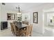 Dining room features a modern table with six chairs, a wine cooler, and a decorative wall mirror at 3220 Southfield Ln # 810, Sarasota, FL 34239