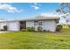 Charming one-story home featuring an attached garage, screen door entry, and lush, well-maintained lawn at 3220 Southfield Ln # 810, Sarasota, FL 34239