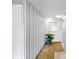 Bright hallway with window and plant, featuring white wood-paneled walls at 3220 Southfield Ln # 810, Sarasota, FL 34239