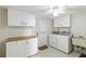 Functional laundry room with a washer, dryer, cabinets and sink at 3220 Southfield Ln # 810, Sarasota, FL 34239