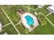 Aerial view of a community pool surrounded by palm trees and lush landscaping at 3220 Southfield Ln # 810, Sarasota, FL 34239