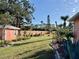 Landscaped backyard featuring a shed, privacy fence, and well-manicured lawn at 501 Cobalt Rd, Englewood, FL 34223