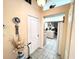 Hallway featuring tile flooring, leading to an open kitchen, and a closet at 501 Cobalt Rd, Englewood, FL 34223