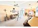 Bright living room featuring a vaulted ceiling, neutral carpet, ceiling fan, and an open floor plan at 501 Cobalt Rd, Englewood, FL 34223