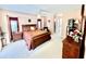 Spacious main bedroom with a luxurious bed, closet doors and dressers at 501 Cobalt Rd, Englewood, FL 34223