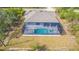 Aerial shot featuring a screen-enclosed pool and spa at 7282 Printer St, Port Charlotte, FL 33981