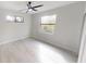 Neutral bedroom with a ceiling fan and light wood-look tile flooring at 7282 Printer St, Port Charlotte, FL 33981