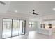 Open-concept living room connected to a modern kitchen, offering a view of the pool through expansive glass doors at 7282 Printer St, Port Charlotte, FL 33981