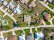 Aerial view outlining a property featuring a screened-in pool, a tidy lawn and shed, situated in a desirable community at 7424 Snow Dr, Englewood, FL 34224