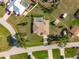 Aerial view outlining the property featuring a screened pool, manicured lawn, and shed at 7424 Snow Dr, Englewood, FL 34224