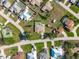 Aerial view showcases a home with a screened pool, tidy landscaping and a shed in a well-kept neighborhood at 7424 Snow Dr, Englewood, FL 34224