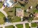 Aerial view of a single-Gathering home featuring a screened pool, storage shed, and well-manicured lawn at 7424 Snow Dr, Englewood, FL 34224