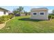 A generous lawn area features a shed with windows at 7424 Snow Dr, Englewood, FL 34224