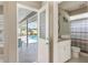 Bathroom with vanity and shower, seen from door with view of pool and patio at 7424 Snow Dr, Englewood, FL 34224