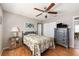 Neutral bedroom with ceiling fan, closet, wood floors and chest of drawers at 7424 Snow Dr, Englewood, FL 34224