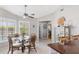 Bright dining area with glass table, rattan chairs, and large window provides a cozy eating space at 7424 Snow Dr, Englewood, FL 34224