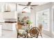 Light-filled dining area featuring rattan chairs and plantation shutters provides a comfortable and inviting space at 7424 Snow Dr, Englewood, FL 34224