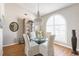 Elegant dining area features a chandelier and large window offering ample natural light at 7424 Snow Dr, Englewood, FL 34224