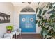 Welcoming front porch with a blue double door, decorative wreaths, and cozy seating at 7424 Snow Dr, Englewood, FL 34224