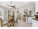 View of an open kitchen with a breakfast bar and dining area offers plenty of space for gatherings at 7424 Snow Dr, Englewood, FL 34224