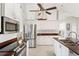 Bright kitchen featuring stainless steel appliances, white cabinets, and ample counter space at 7424 Snow Dr, Englewood, FL 34224