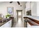 Well-lit kitchen with stainless steel appliances, white cabinets, and ample counter space for cooking at 7424 Snow Dr, Englewood, FL 34224