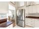 Bright kitchen features stainless steel appliances, white cabinetry, and an adjacent breakfast nook with a chandelier at 7424 Snow Dr, Englewood, FL 34224