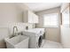 Well-lit laundry room with a sink, washer, and dryer at 7424 Snow Dr, Englewood, FL 34224