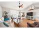 Bright living room with vaulted ceilings, fan, and an open floor plan provides a spacious area for relaxation at 7424 Snow Dr, Englewood, FL 34224