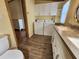 Bathroom with a white dual-sink vanity and a washer and dryer at 810 Manchester Ct, Englewood, FL 34223