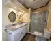 Bathroom featuring double sink vanity, and a glass shower at 810 Manchester Ct, Englewood, FL 34223