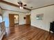 Spacious bedroom featuring wood beam ceiling, ceiling fan, wood floor, and attached bath at 810 Manchester Ct, Englewood, FL 34223