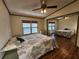 Bedroom with wood floors, a ceiling fan and a mirrored closet at 810 Manchester Ct, Englewood, FL 34223