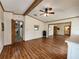 Bright bedroom with wood floors, beam ceiling, and a mirrored closet at 810 Manchester Ct, Englewood, FL 34223