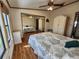 Bedroom with wood floors, a ceiling fan, and a wardrobe at 810 Manchester Ct, Englewood, FL 34223