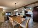 Open-concept dining area with a wooden table and chairs, seamlessly flowing into the kitchen and living room at 810 Manchester Ct, Englewood, FL 34223