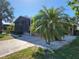 A single-story home with a screened porch, a carport and well-maintained landscaping at 810 Manchester Ct, Englewood, FL 34223