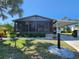 Charming single-story home featuring a screened-in porch, carport, and manicured landscaping at 810 Manchester Ct, Englewood, FL 34223