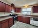 Functional kitchen with ample counter space, updated stainless steel appliances, and plenty of cabinet space at 810 Manchester Ct, Englewood, FL 34223