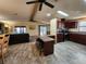 This is the living room and kitchen area, featuring wood accents, countertops, and flooring at 810 Manchester Ct, Englewood, FL 34223