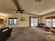 Living room with a ceiling fan and a view of the sunroom at 810 Manchester Ct, Englewood, FL 34223