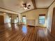 This is the main bedroom with a walk-in closet, wood floors, and natural light from the surrounding windows at 810 Manchester Ct, Englewood, FL 34223