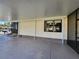 Covered patio with a large concrete pad, brick accents, and a view of the front yard at 810 Manchester Ct, Englewood, FL 34223