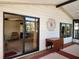 Covered patio featuring sliding glass doors to the interior and a decorative wall accent at 810 Manchester Ct, Englewood, FL 34223