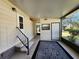 View of the enclosed patio featuring concrete flooring, a decorative rug, and access to the backyard at 810 Manchester Ct, Englewood, FL 34223