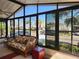 Cozy sunroom featuring large windows, comfortable furniture, and a relaxing atmosphere at 810 Manchester Ct, Englewood, FL 34223