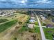 Aerial view of the neighborhood with golf course and community at 934 Rotonda Cir, Rotonda West, FL 33947